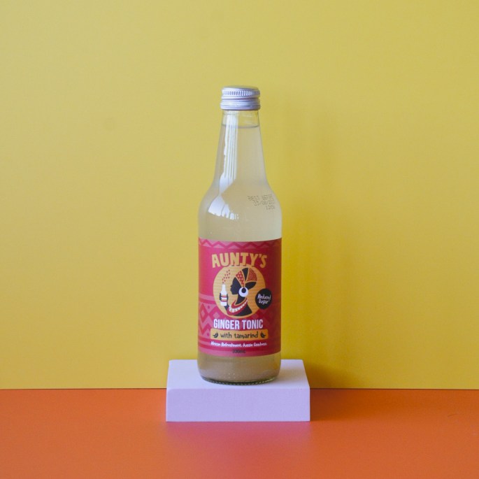 Yellow wall, orange floor, a bottle of ginger tonic on a pink podium