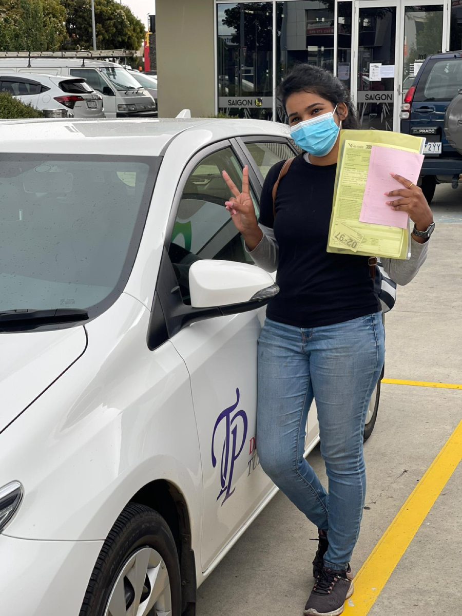 Woman wearing a blue face mask holds papers