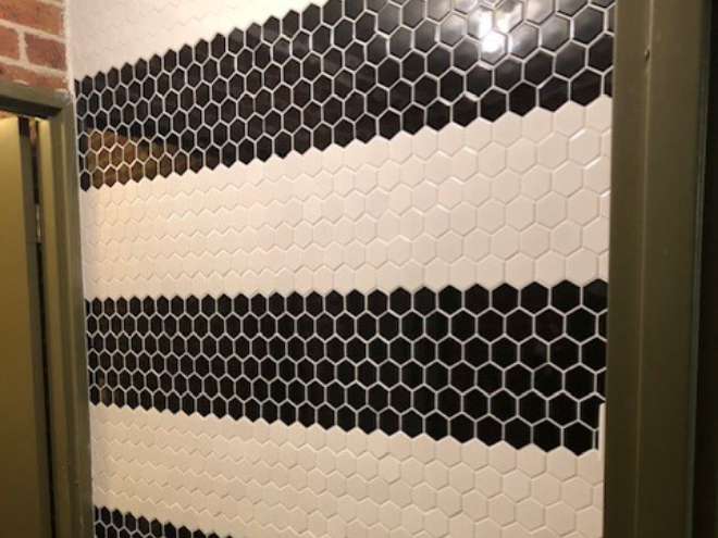 Wall of honeycomb tiles in black and white stripes